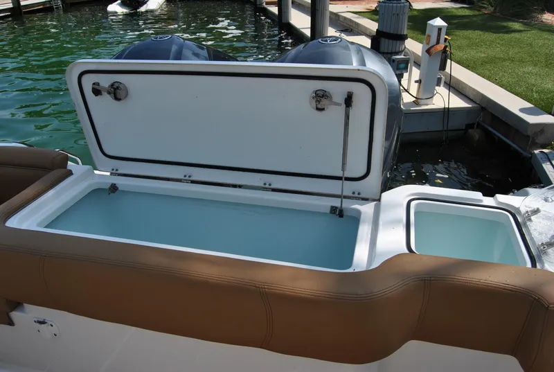 Slide: The Image of 2020 Sea Hunt Gamefish 30 boat with open storage compartment at dock. - 16