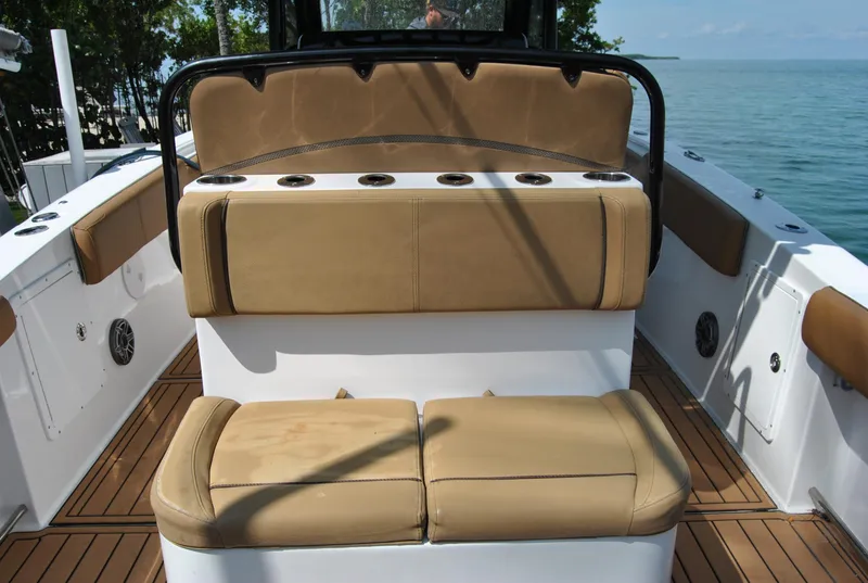 Slide: The Image of 2020 Sea Hunt Gamefish 30 boat interior with tan seating and rod holders. - 18