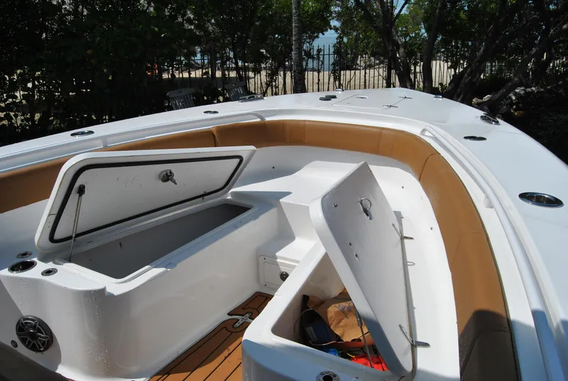 Slide: The Image of 2020 Sea Hunt Gamefish 30 boat with open storage compartments on deck. - 19