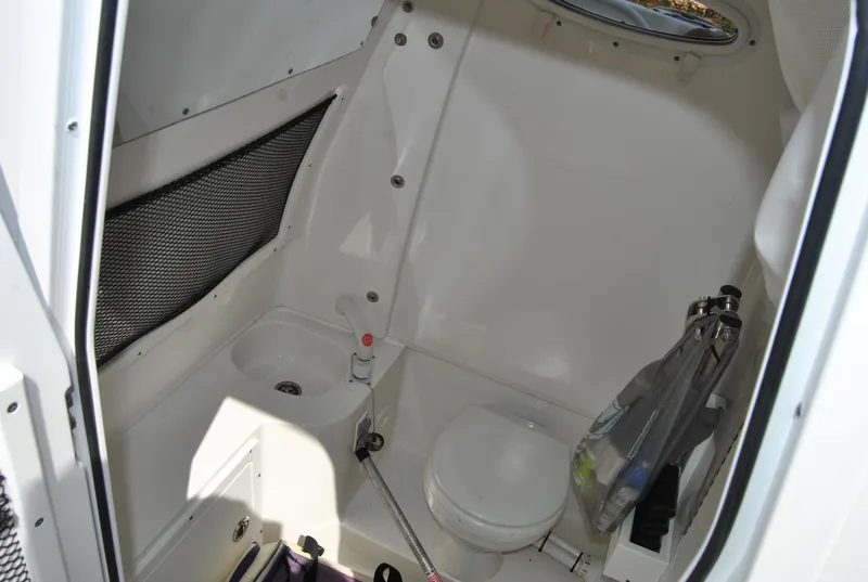 Slide: The Image of 2020 Sea Hunt Gamefish 30 boat interior with toilet and storage space. - 21