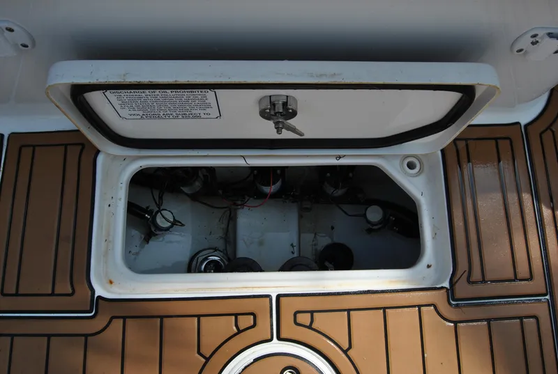Slide: The Image of Open hatch on 2020 Sea Hunt Gamefish 30 boat deck, showing interior components. - 23