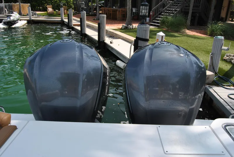 Slide: The Image of Twin outboard engines on a 2020 Sea Hunt Gamefish 30 at a dock. - 25