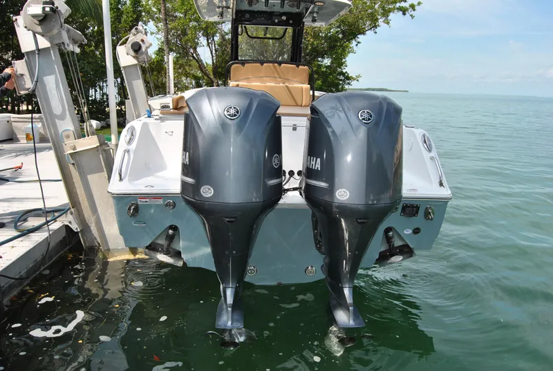 Slide: The Image of 2020 Sea Hunt Gamefish 30 with dual Yamaha outboard motors docked by the water. - 26
