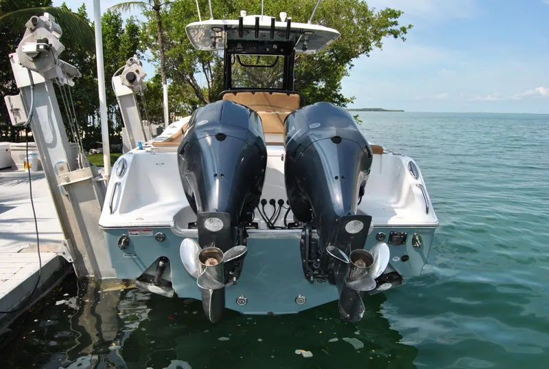 Slide: The Image of 2020 Sea Hunt Gamefish 30 with dual outboard motors docked by the water. - 3