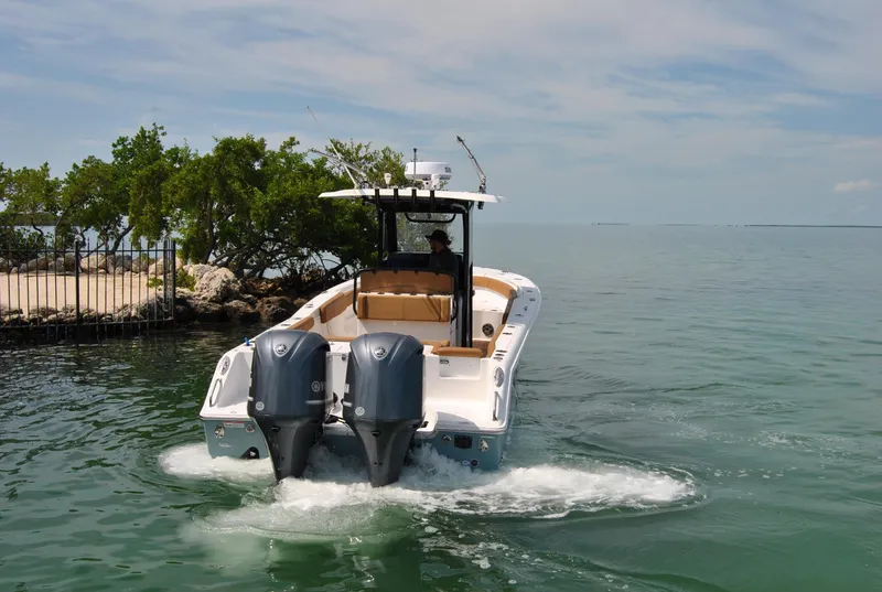 Slide: The Image of 2020 Sea Hunt Gamefish 30 boat cruising on calm water near a small island. - 30