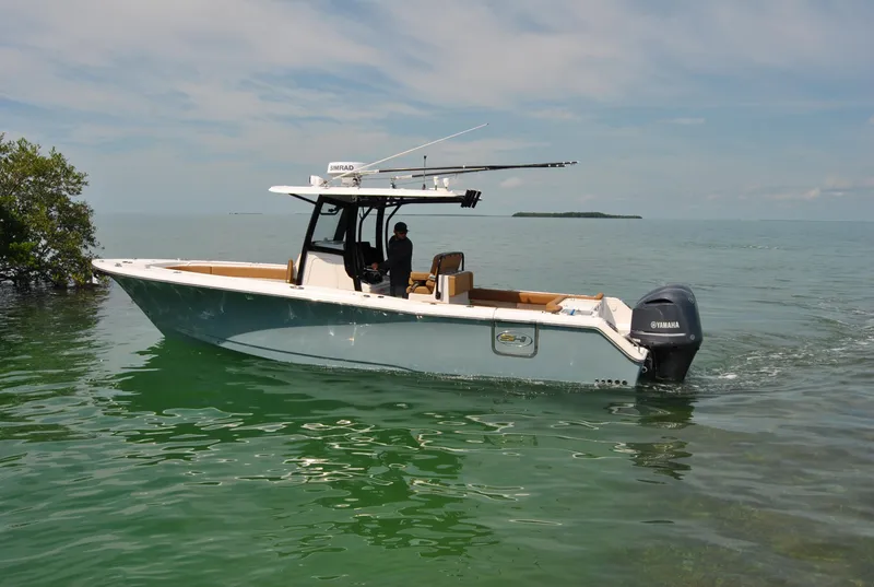 Slide: The Image of 2020 Sea Hunt Gamefish 30 boat on calm water, featuring Yamaha outboard motor. - 35