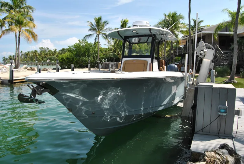 Slide: The Image of 2020 Sea Hunt Gamefish 30 boat docked in tropical marina setting. - 5