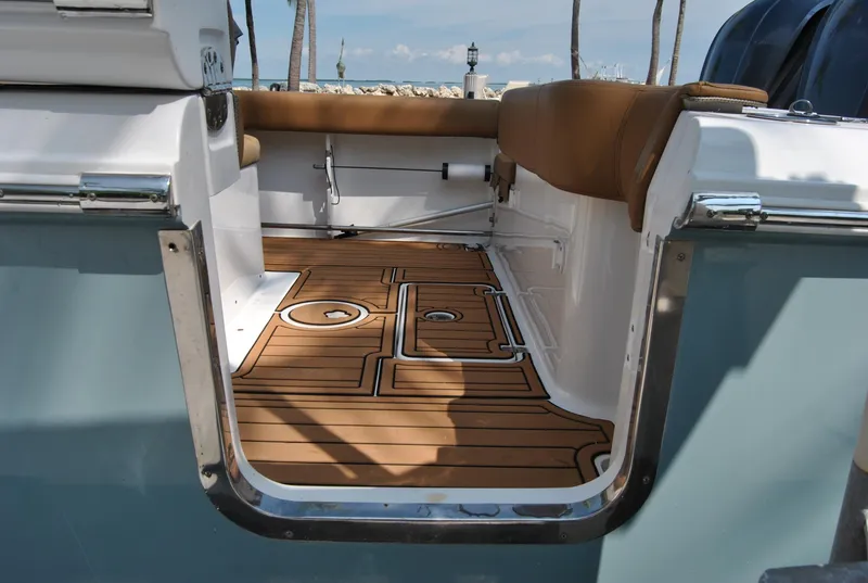 Slide: The Image of 2020 Sea Hunt Gamefish 30 boat interior with teak flooring and cushioned seating. - 7