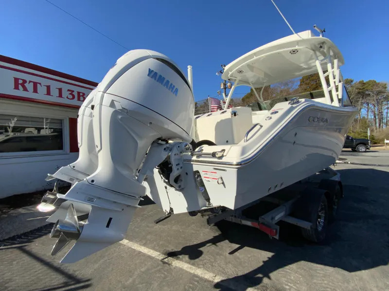 Slide: The Image of 2025 Cobia 280 Dual Console boat with Yamaha engine on a trailer. - 11