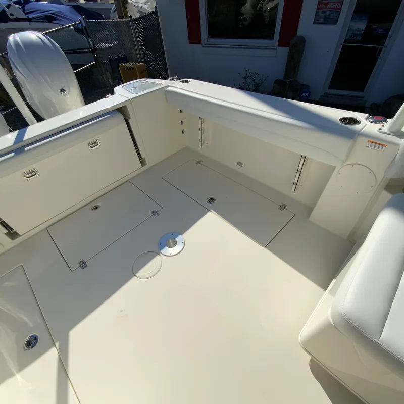 Slide: The Image of 2025 Cobia 280 Dual Console boat interior with storage compartments and seating. - 15