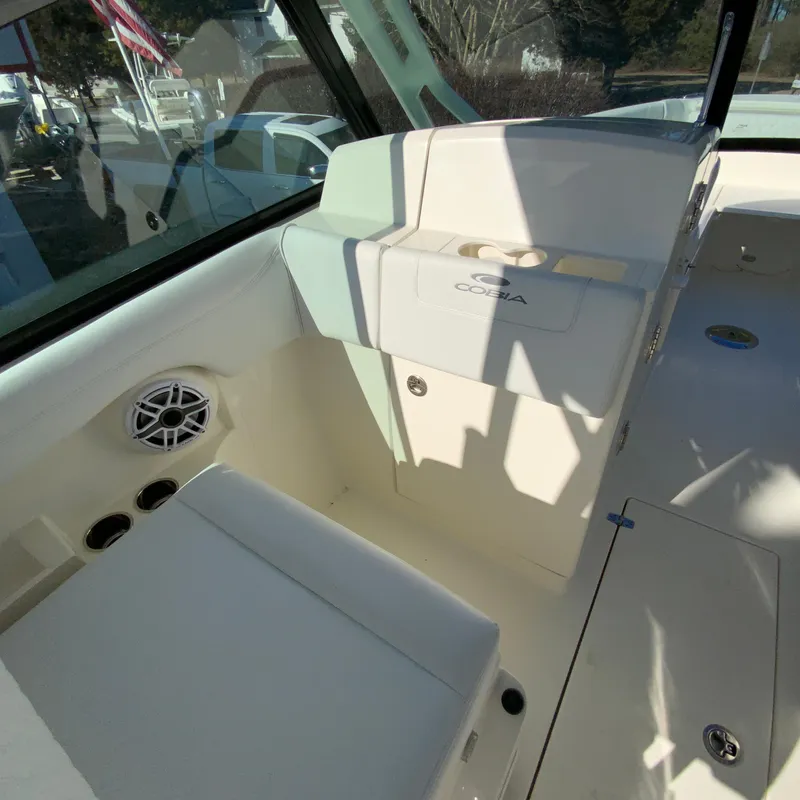 Slide: The Image of 2025 Cobia 280 Dual Console interior with seating and speaker, showcasing luxury design. - 23