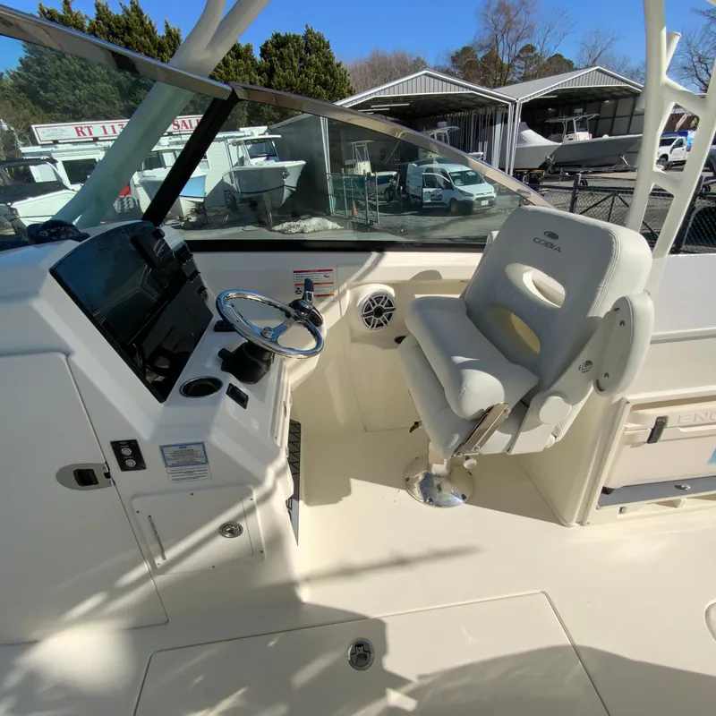 Slide: The Image of 2025 Cobia 280 Dual Console boat interior with helm and captain's chair. - 26