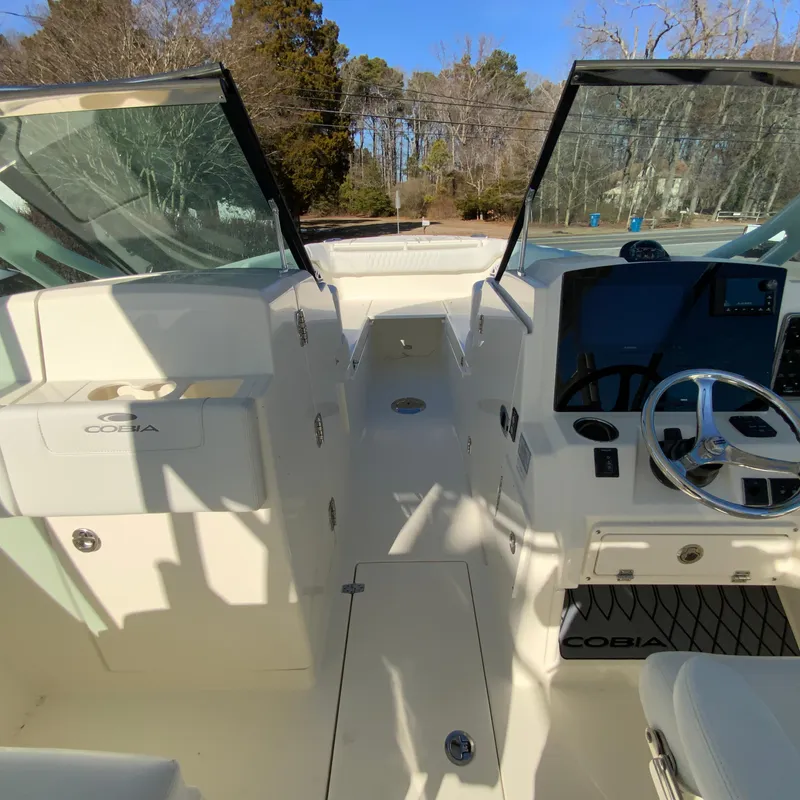 Slide: The Image of 2025 Cobia 280 Dual Console boat interior with steering wheel and dashboard. - 28