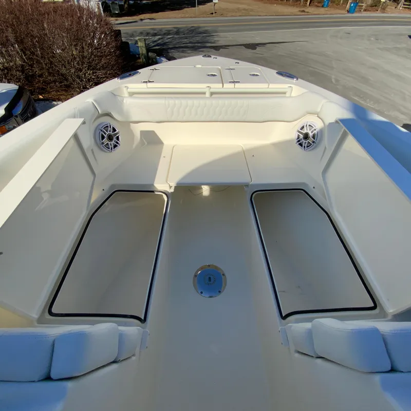 Slide: The Image of 2025 Cobia 280 Dual Console boat interior with spacious seating and storage compartments. - 29