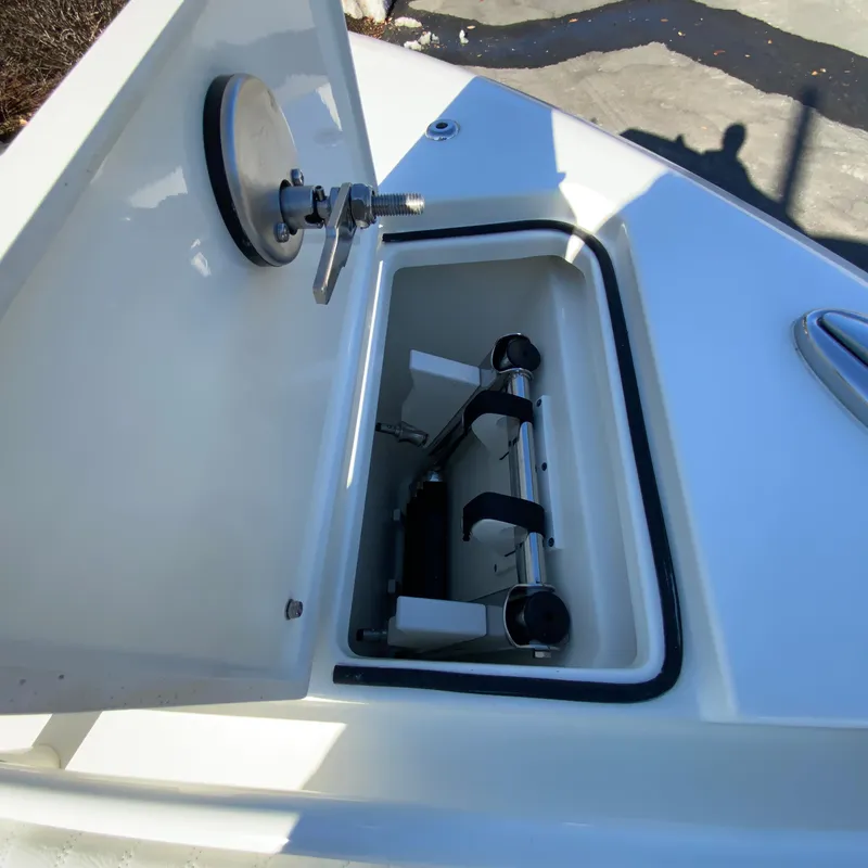 Slide: The Image of Open storage compartment on 2025 Cobia 280 Dual Console boat. - 32
