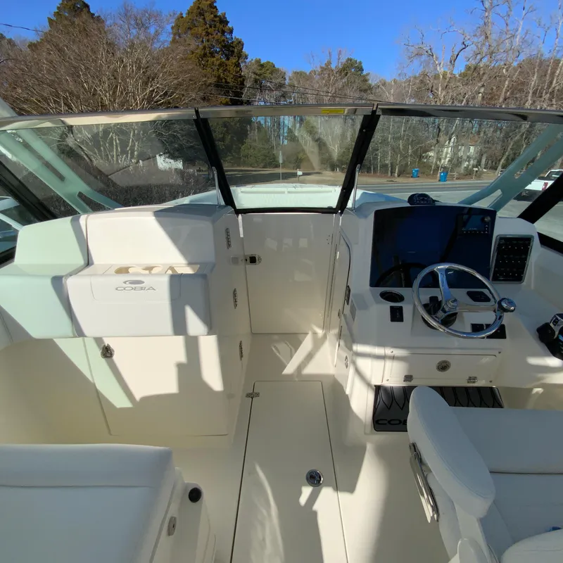 Slide: The Image of 2025 Cobia 280 Dual Console boat interior with steering wheel and dashboard. - 40