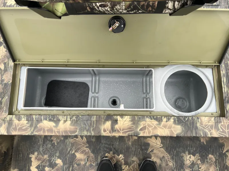 Slide: The Image of 2024 Lund 1870 Predator SC boat storage compartment with camouflage design. - 10
