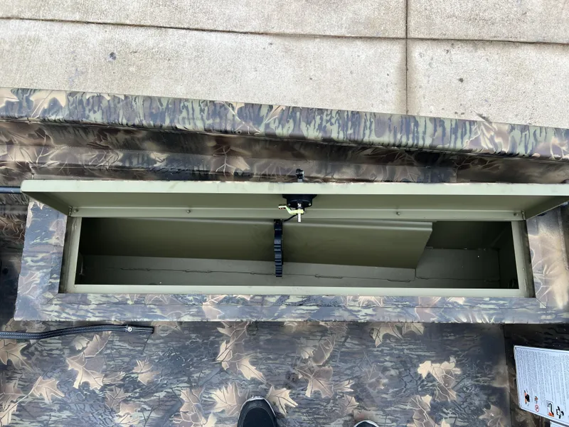 Slide: The Image of 2024 Lund 1870 Predator SC boat storage compartment with camouflage design. - 14