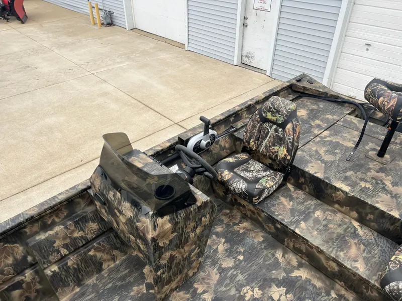 Slide: The Image of 2024 Lund 1870 Predator SC boat with camouflage interior and steering console. - 15