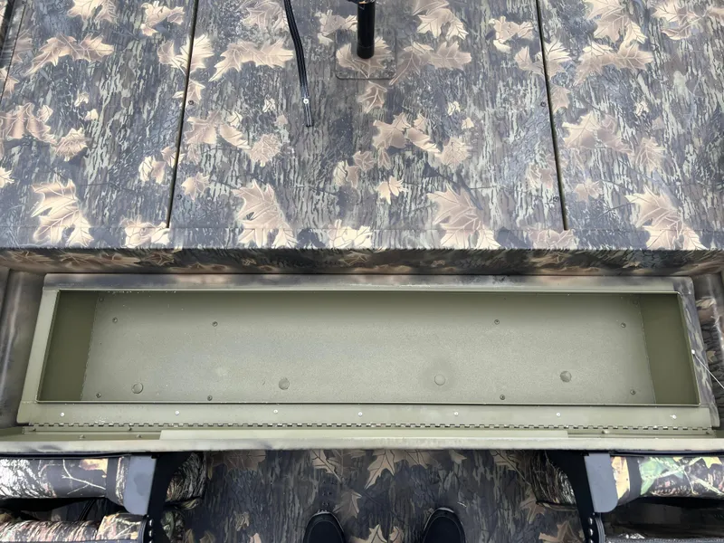 Slide: The Image of 2024 Lund 1870 Predator SC boat with camo pattern and storage compartment. - 17