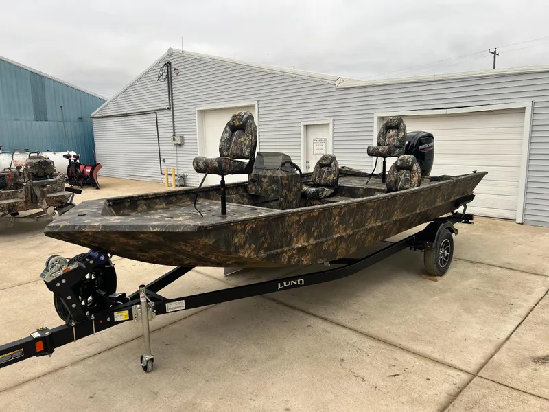 Slide: The Image of 2024 Lund 1870 Predator SC boat with camouflage design on trailer. - 2