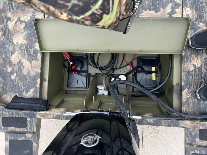 Slide: The Image of 2024 Lund 1870 Predator SC boat battery compartment with camouflage design. - 21