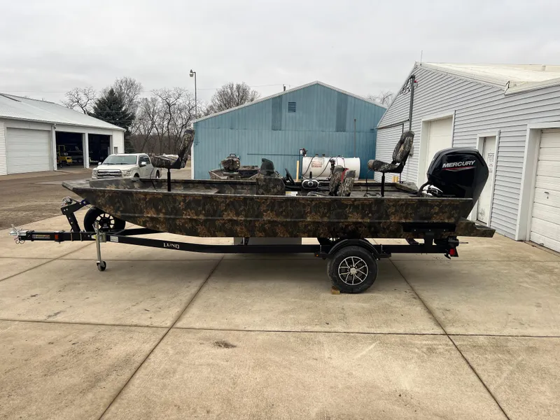 Slide: The Image of 2024 Lund 1870 Predator SC boat on trailer, camo design, Mercury outboard motor. - 3