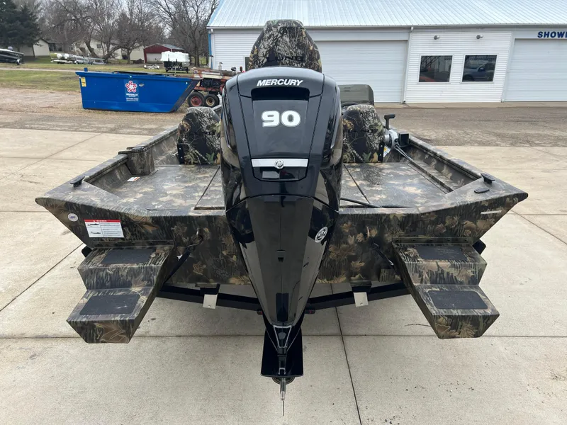 Slide: The Image of 2024 Lund 1870 Predator SC boat with Mercury 90 engine, camo design, rear view. - 5