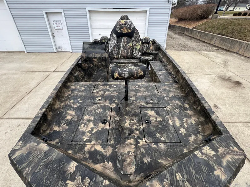 Slide: The Image of 2024 Lund 1870 Predator SC camo fishing boat with storage compartments and seating. - 7