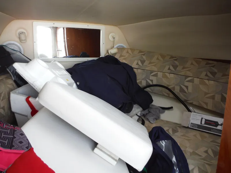 Slide: The Image of Interior cabin of a 2006 Four Winns 255 Sundowner boat with cluttered seating area. - 15