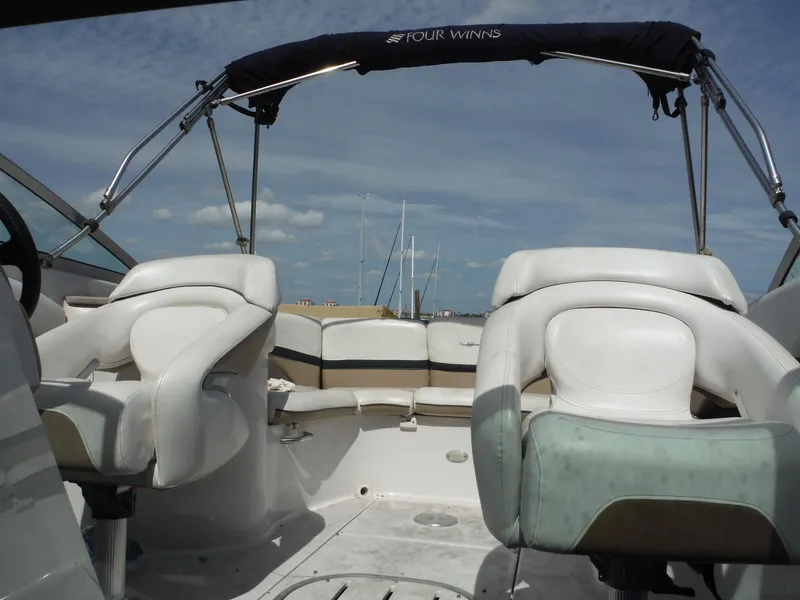 Slide: The Image of 2006 Four Winns 255 Sundowner boat interior with white seating and canopy. - 16