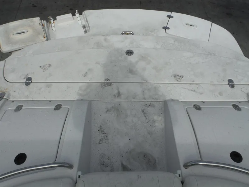 Slide: The Image of 2006 Four Winns 255 Sundowner boat deck, showing wear and dirt. - 27