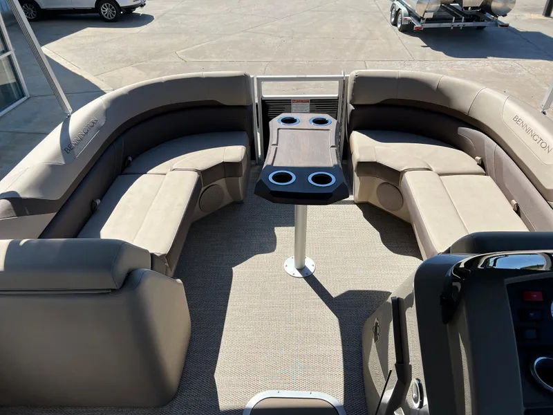 Slide: The Image of 2024 Bennington 22 SXSR pontoon boat interior with beige seating and table. - 7