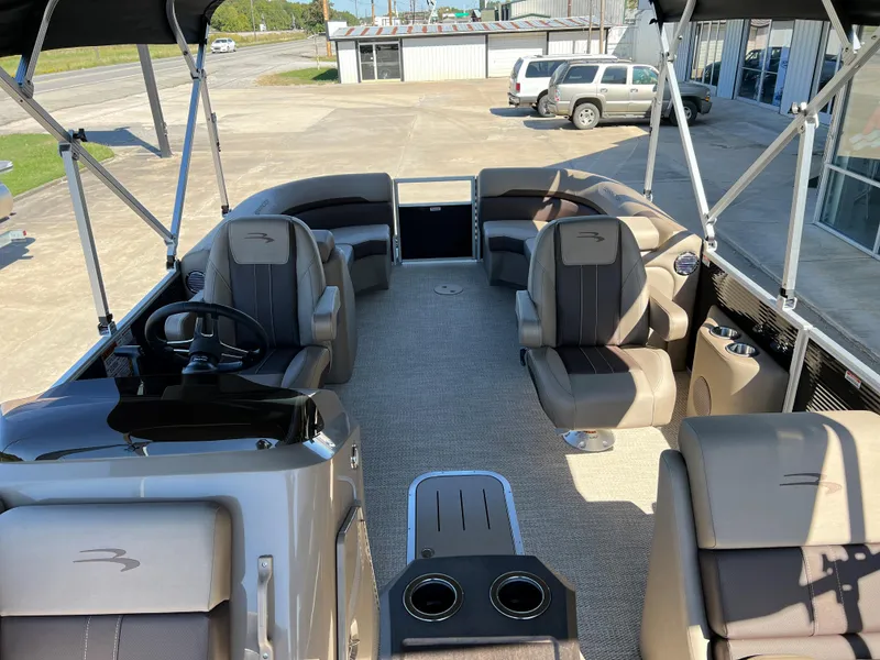 Slide: The Image of 2024 Bennington 22 SXSR pontoon boat interior with seating and steering console. - 8