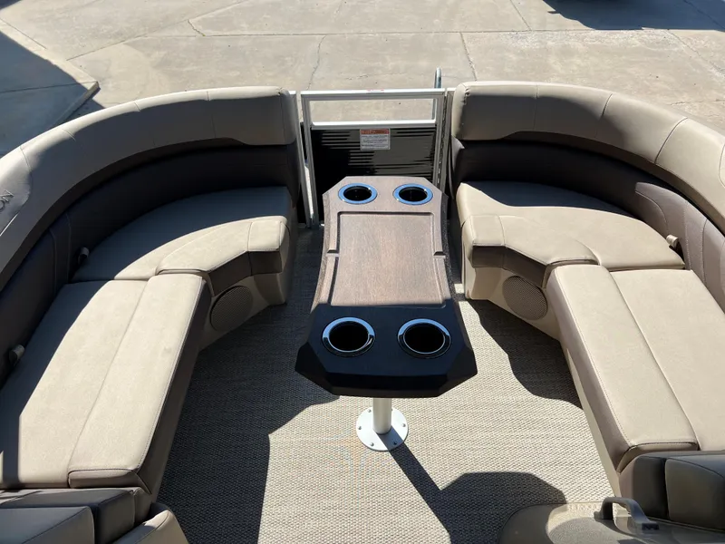Slide: The Image of 2024 Bennington 22 SXSR boat interior with beige seating and a central table. - 9