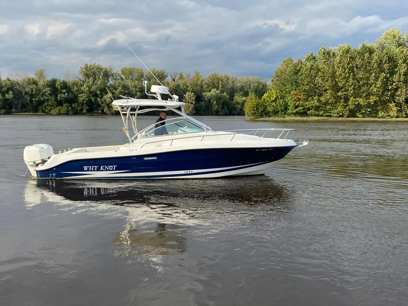Slide: The Image of 2007 Hydra-Sports 2900VX boat cruising on a calm river with lush green trees in the background. - 1