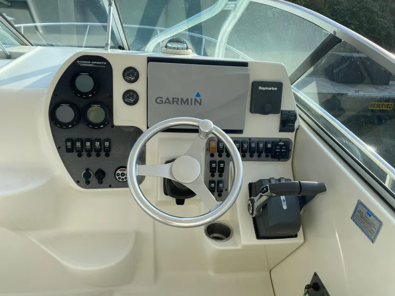 Slide: The Image of 2007 Hydra-Sports 2900VX boat helm with Garmin navigation system and Raymarine controls. - 12