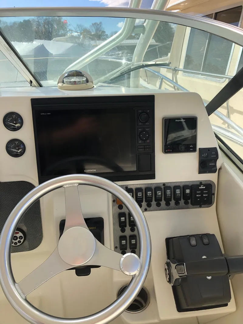 Slide: The Image of 2007 Hydra-Sports 2900VX boat helm with steering wheel and navigation controls. - 13