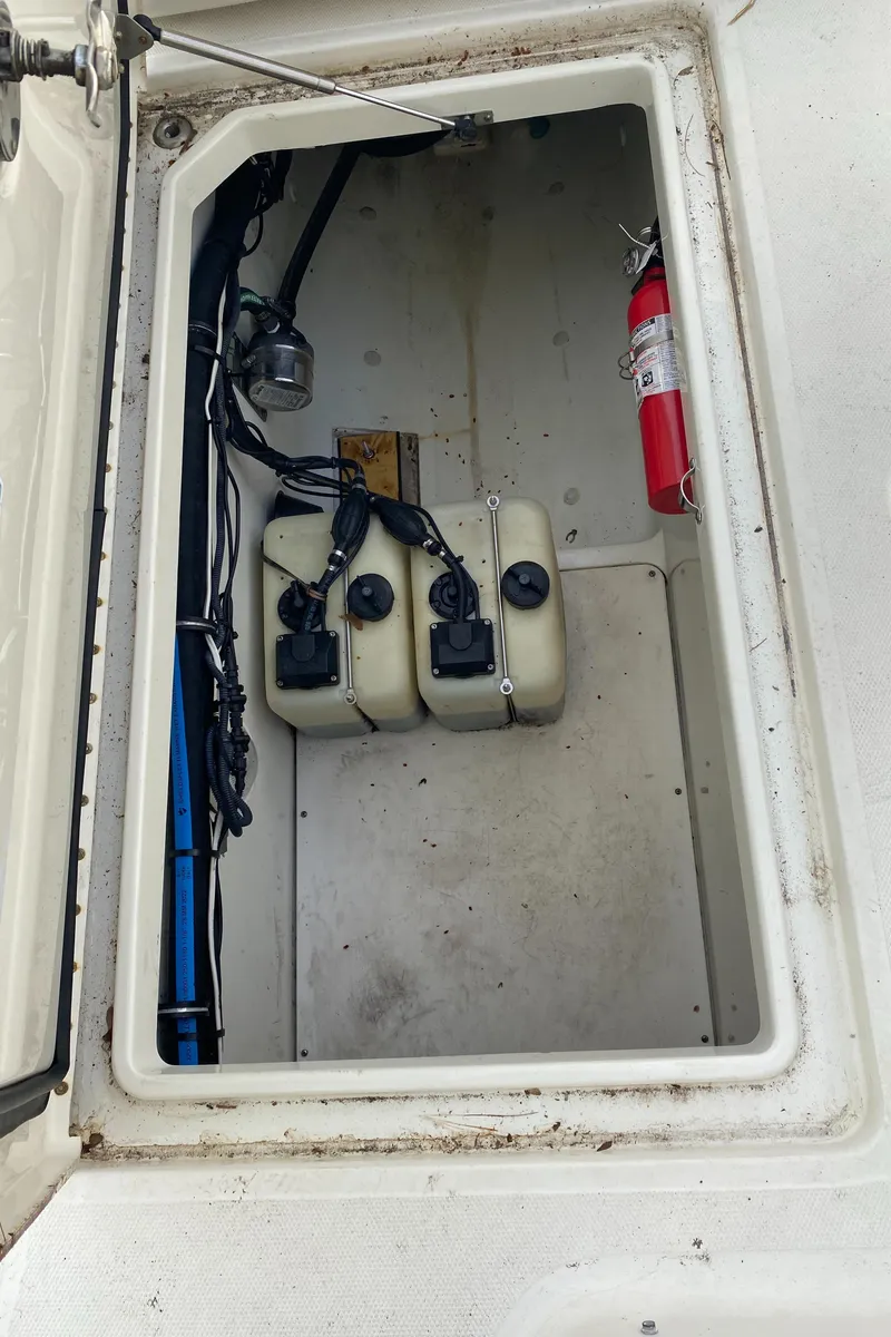 Slide: The Image of 2007 Hydra-Sports 2900VX boat storage compartment with fire extinguisher and equipment. - 23