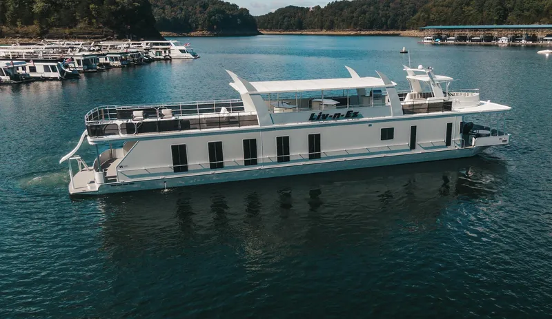 Slide: The Image of Sharpe 20 x 100 houseboat, 2007 model, cruising on a serene lake. - 12