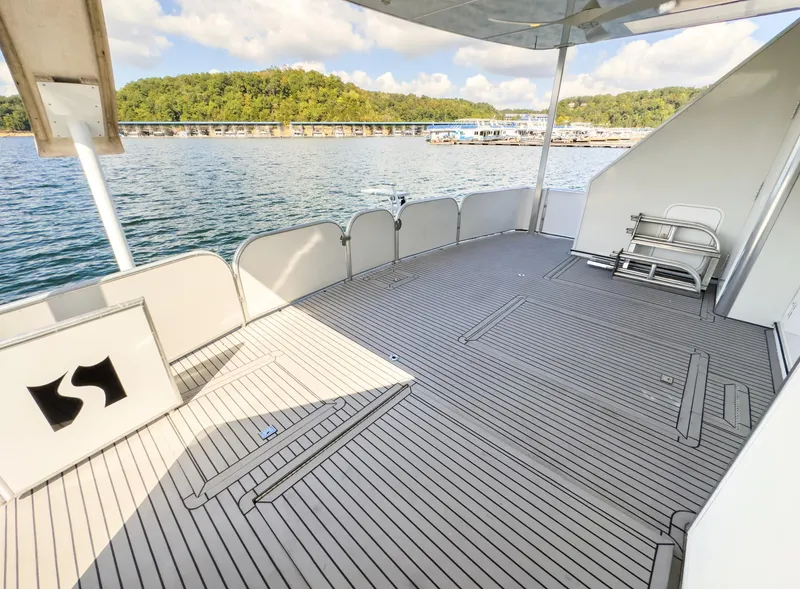 Slide: The Image of Spacious deck of a 2007 Sharpe 20 x 100 houseboat on a serene lake. - 17