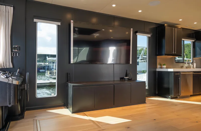 Slide: The Image of Modern interior of 2007 Sharpe 20 x 100 houseboat with large TV and waterfront view. - 19