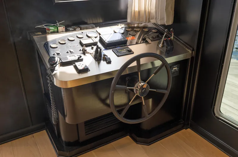 Slide: The Image of Control panel of a 2007 Sharpe 20 x 100 boat with steering wheel and navigation instruments. - 21