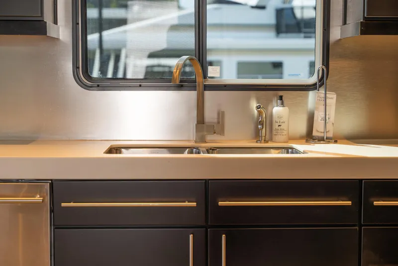 Slide: The Image of Modern kitchen sink area in a 2007 Sharpe 20 x 100 houseboat. - 24