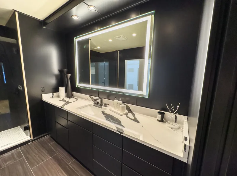Slide: The Image of Modern black bathroom with illuminated mirror, double sink vanity, and sleek design. Sharpe 20 x 100, 2007. - 26