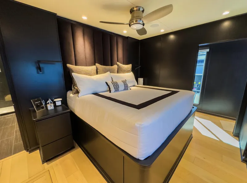 Slide: The Image of Modern bedroom with black walls, stylish bed, and ceiling fan in a Sharpe 20 x 100 houseboat, 2007. - 28
