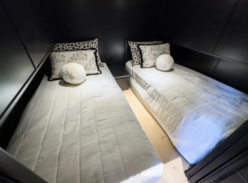 Slide: The Image of Twin beds with decorative pillows in a 2007 Sharpe 20 x 100 houseboat cabin. - 31