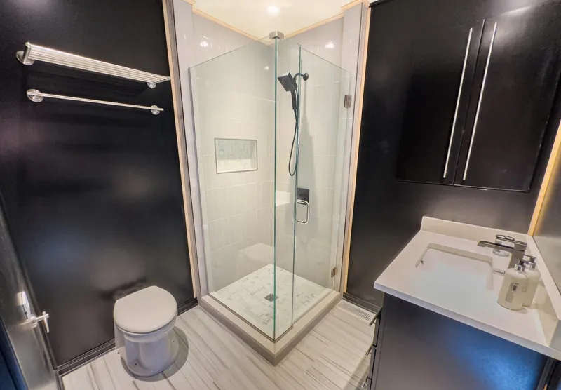 Slide: The Image of Modern bathroom with glass shower enclosure, black cabinets, and white fixtures, Sharpe 20 x 100, 2007. - 32
