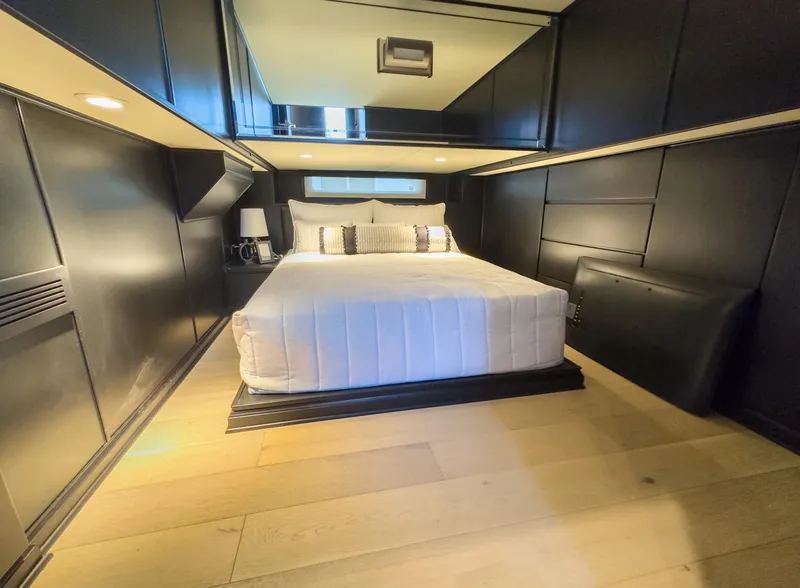 Slide: The Image of Modern bedroom in a 2007 Sharpe 20 x 100 houseboat with sleek black walls and wooden flooring. - 34
