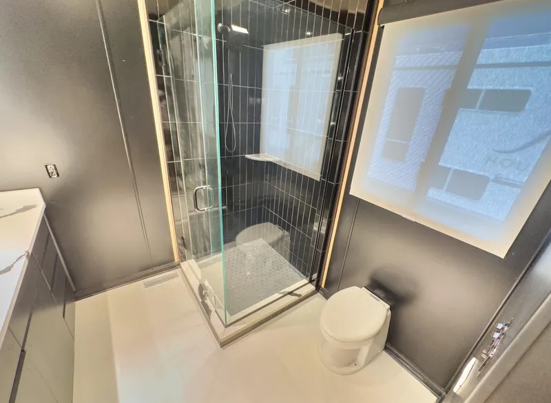 Slide: The Image of Modern bathroom with glass shower, toilet, and sleek design in a 2007 Sharpe 20 x 100 model. - 36